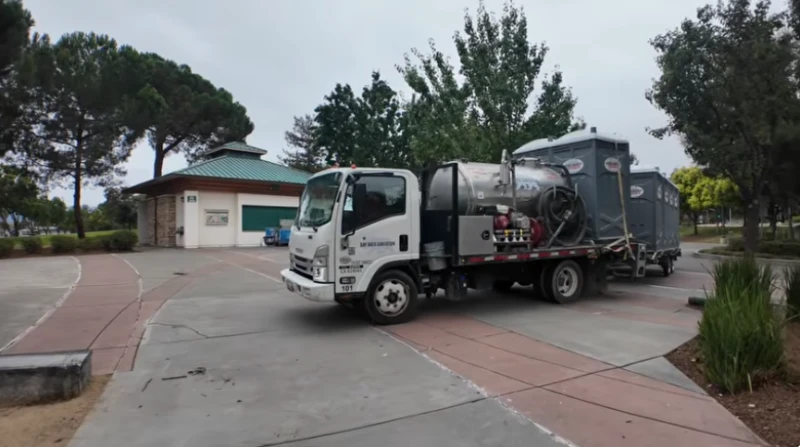 Service truck and portable toilets set up at a park